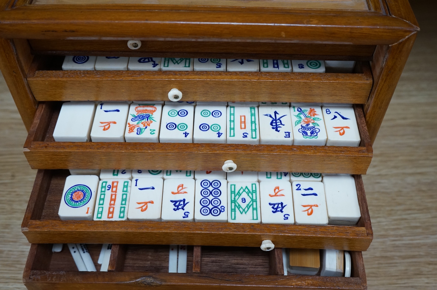 A Chinese carved boxed mahjong set and stands, box 24 cm high including handle